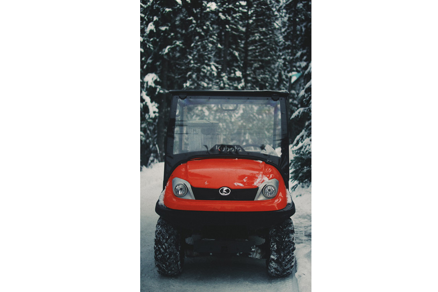 A red golf cart’s tires upgraded for winter