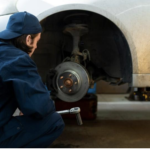 Mechanic inspecting car brake pads for wear and damage